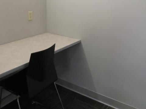 Small room with a single chair and desk space